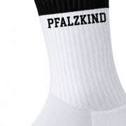 Nahaufnahme des schwarzen PFALZKIND Aufdrucks auf weißer gerippter Socke